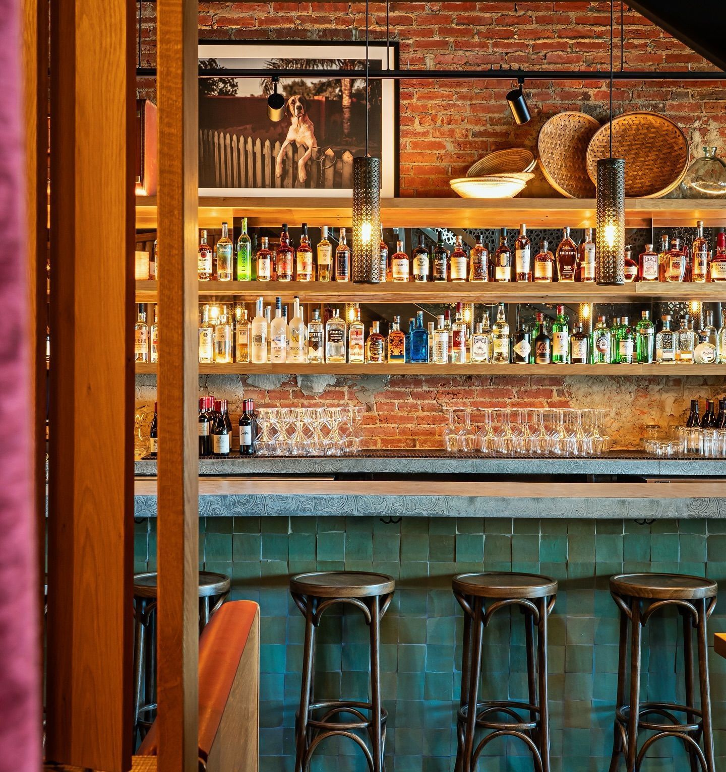 A bar with a lot of bottles on the shelves