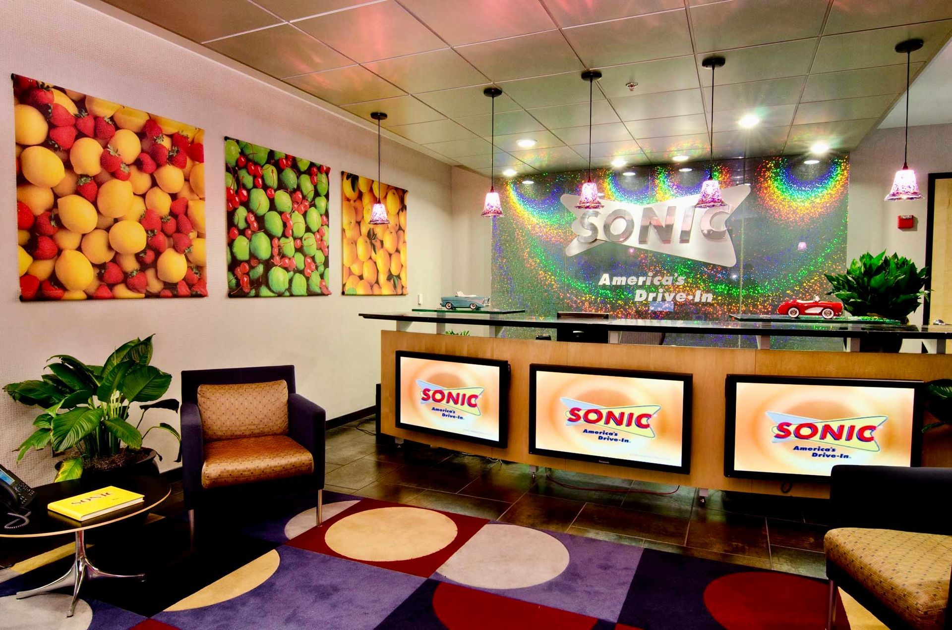 SONIC fast-food lobby with colorful wall art, front counter, and waiting chairs