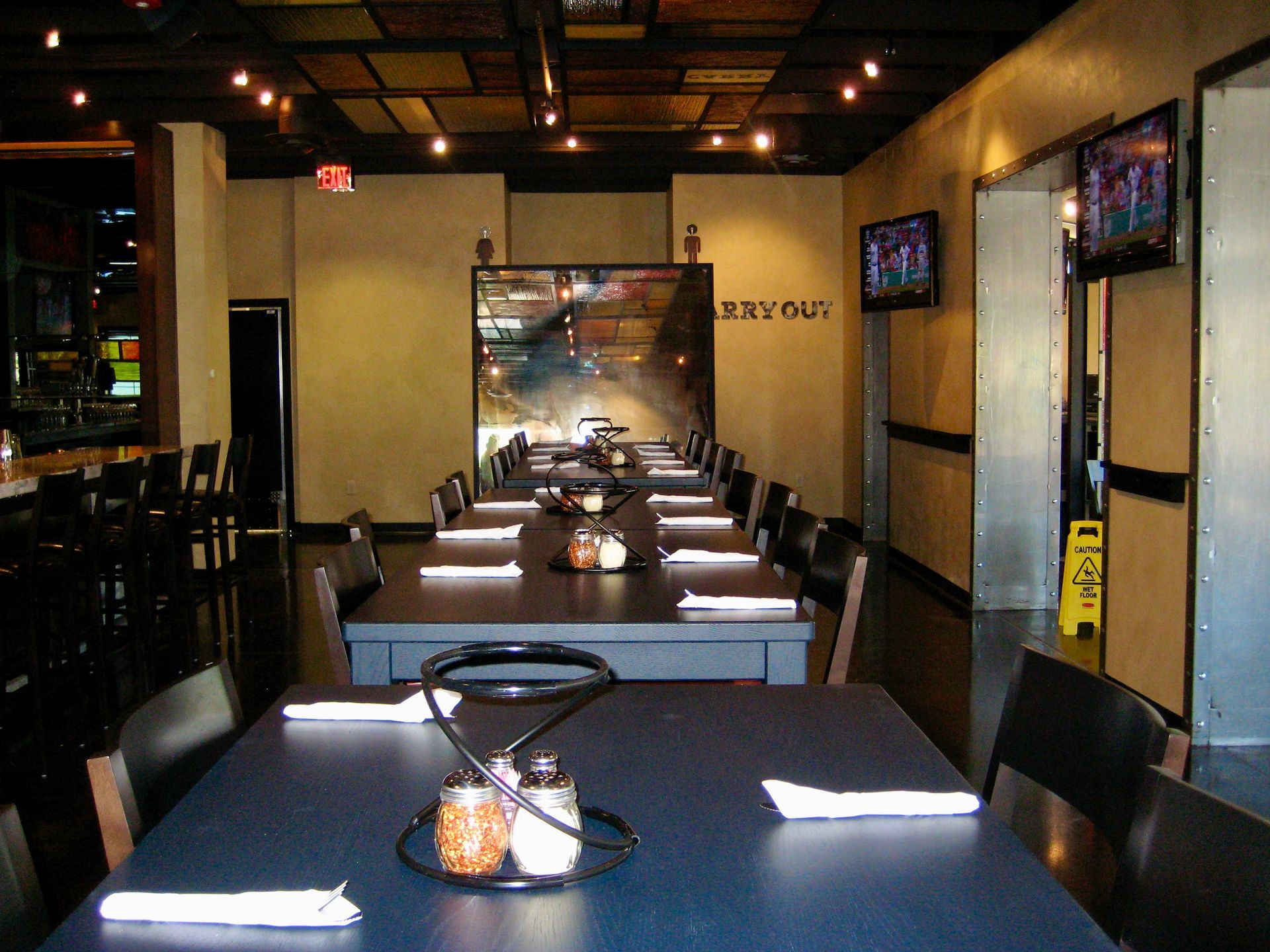 A restaurant with a large framed antique mirror