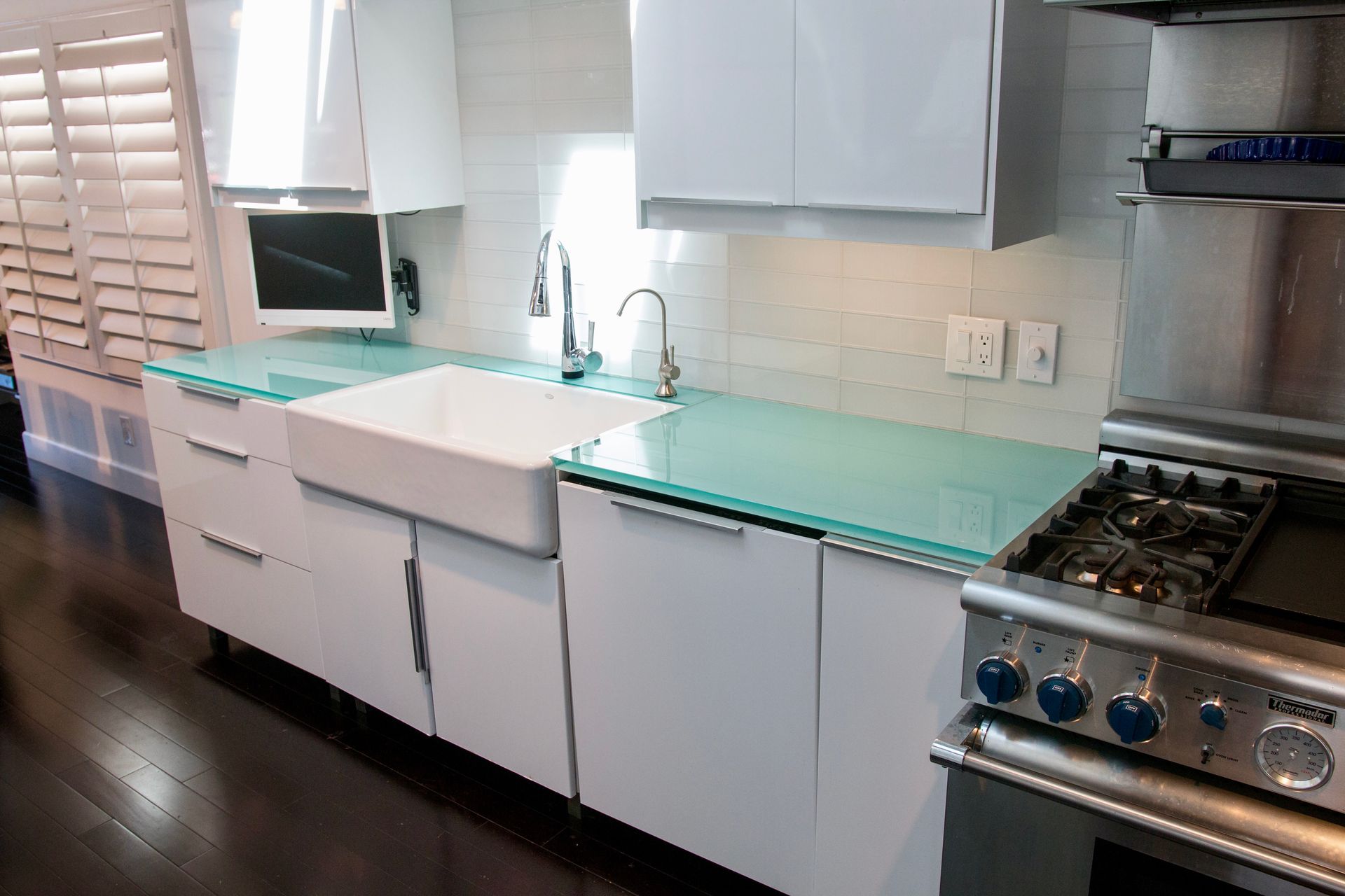 A kitchen with white cabinets and stainless steel appliances