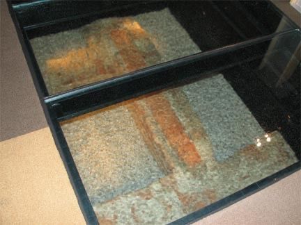 The original foundation of the Jamestown Statehouse revealed by glass flooring. The original foundation of the Jamestown Statehouse revealed by glass flooring.
