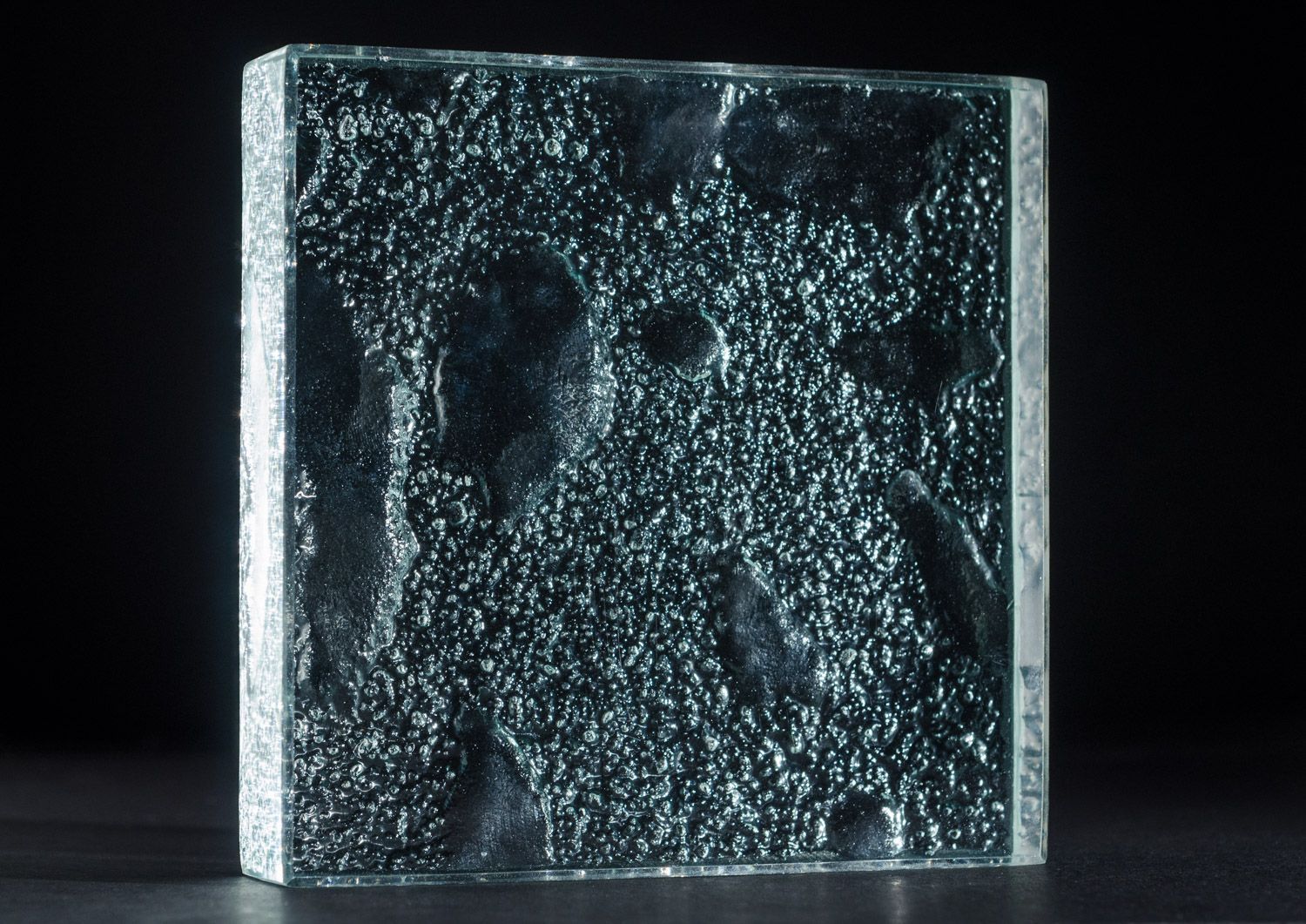 lunar suface textured glass countertop with a black background