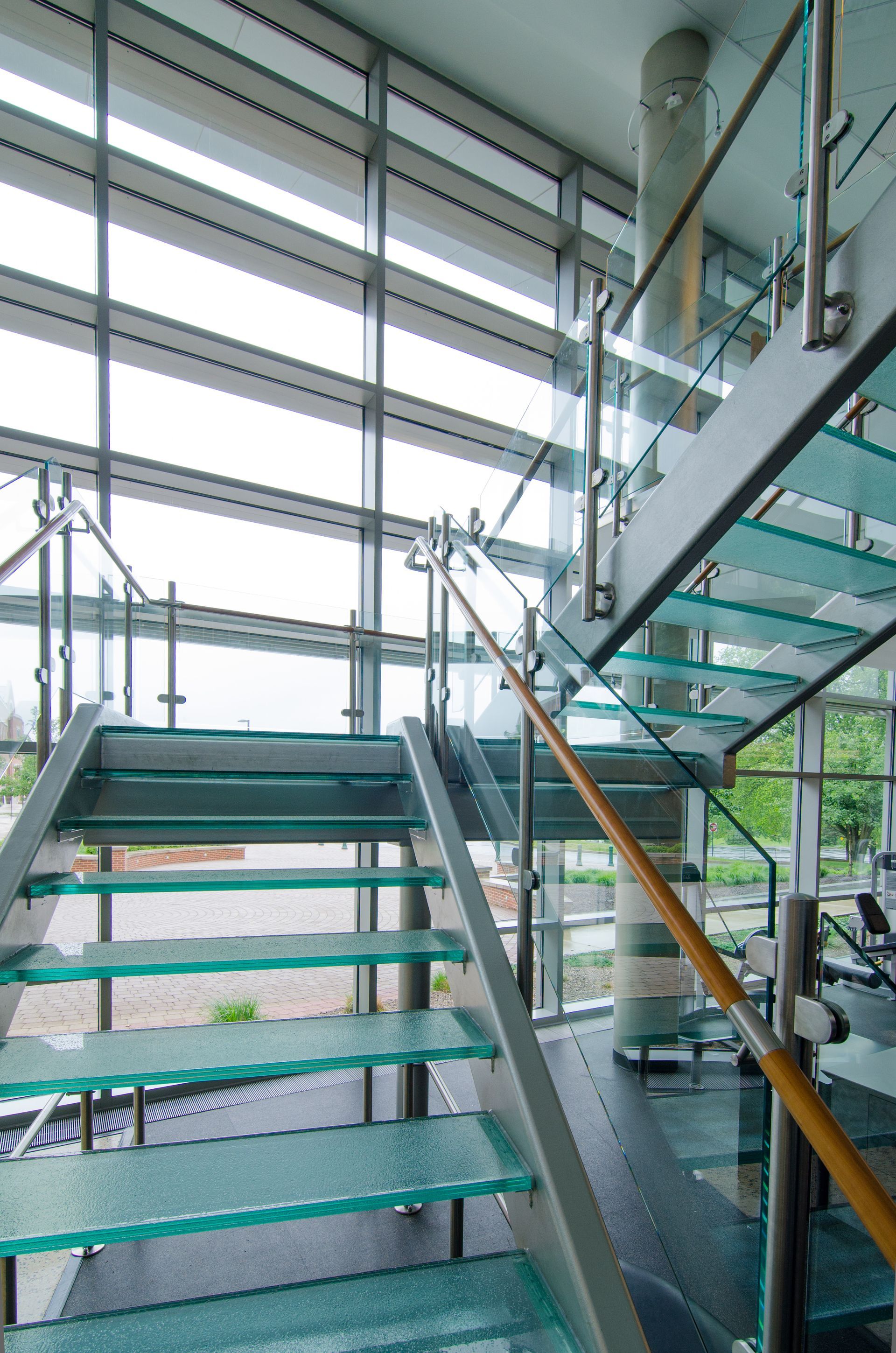 Modern glass staircase inside a bright multi-level building
