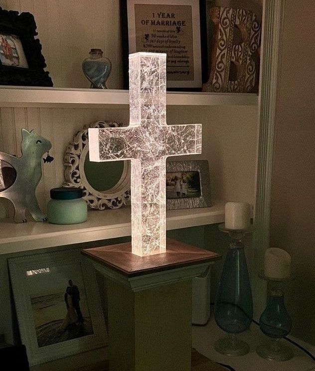 A glass tombstone in the shape of a cross with texture inside the glass. A glass tombstone in the shape of a cross with texture inside the glass.