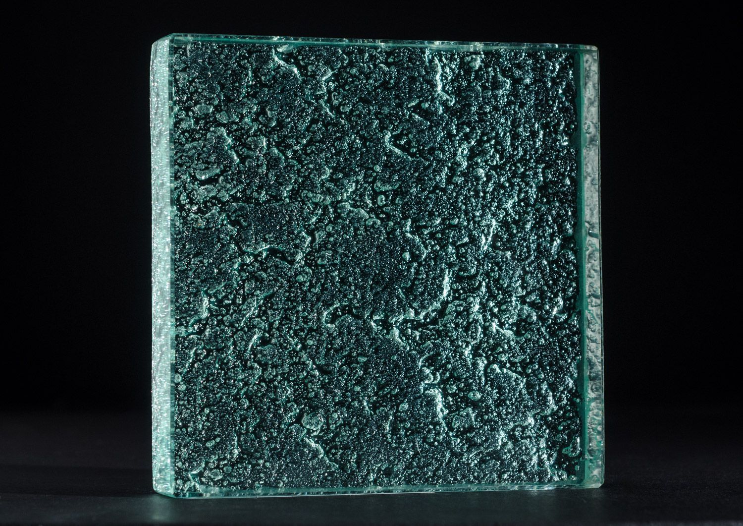 A piece of green natural textured counter top glass