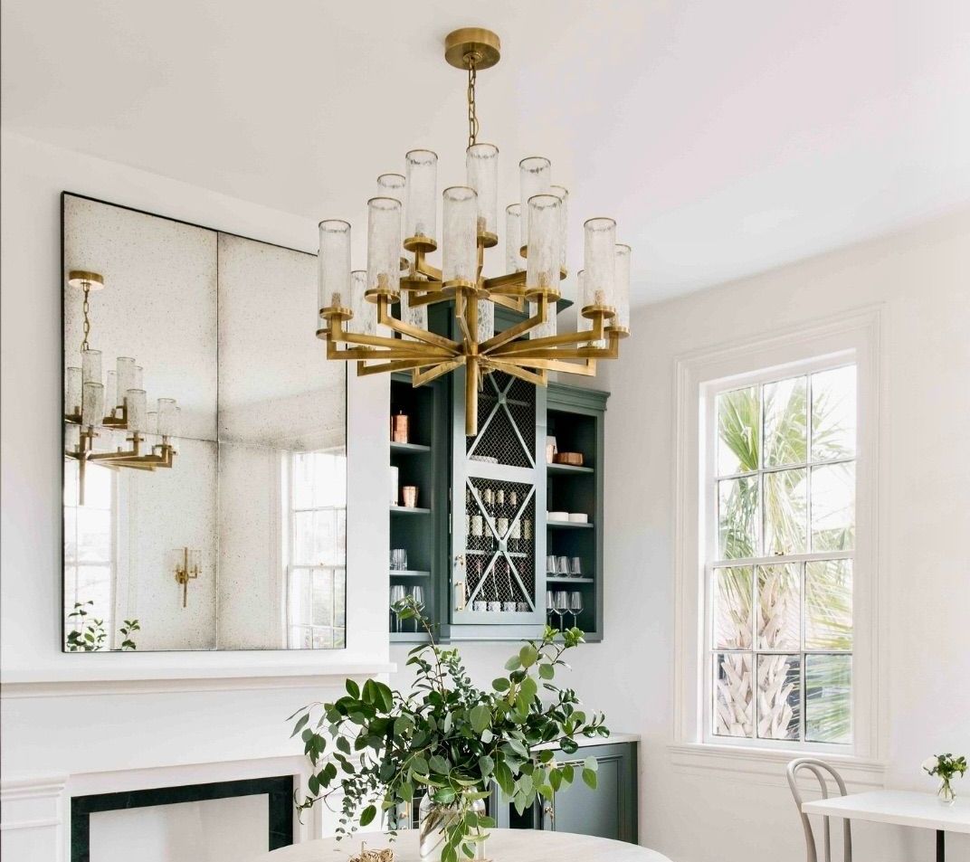 There is a chandelier hanging from the ceiling in the dining room.