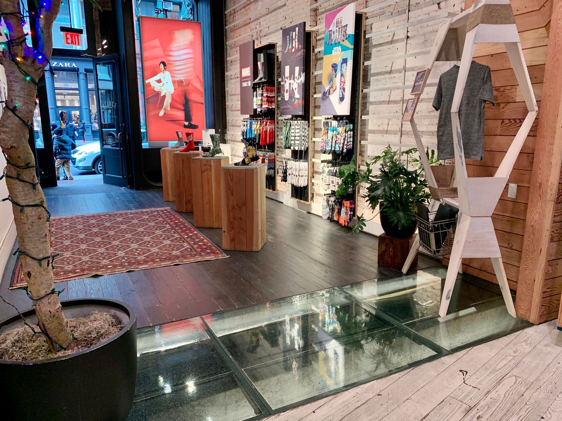 Shop interior with wooden shelves, glass floor, and merchandise displays. Glass Floors