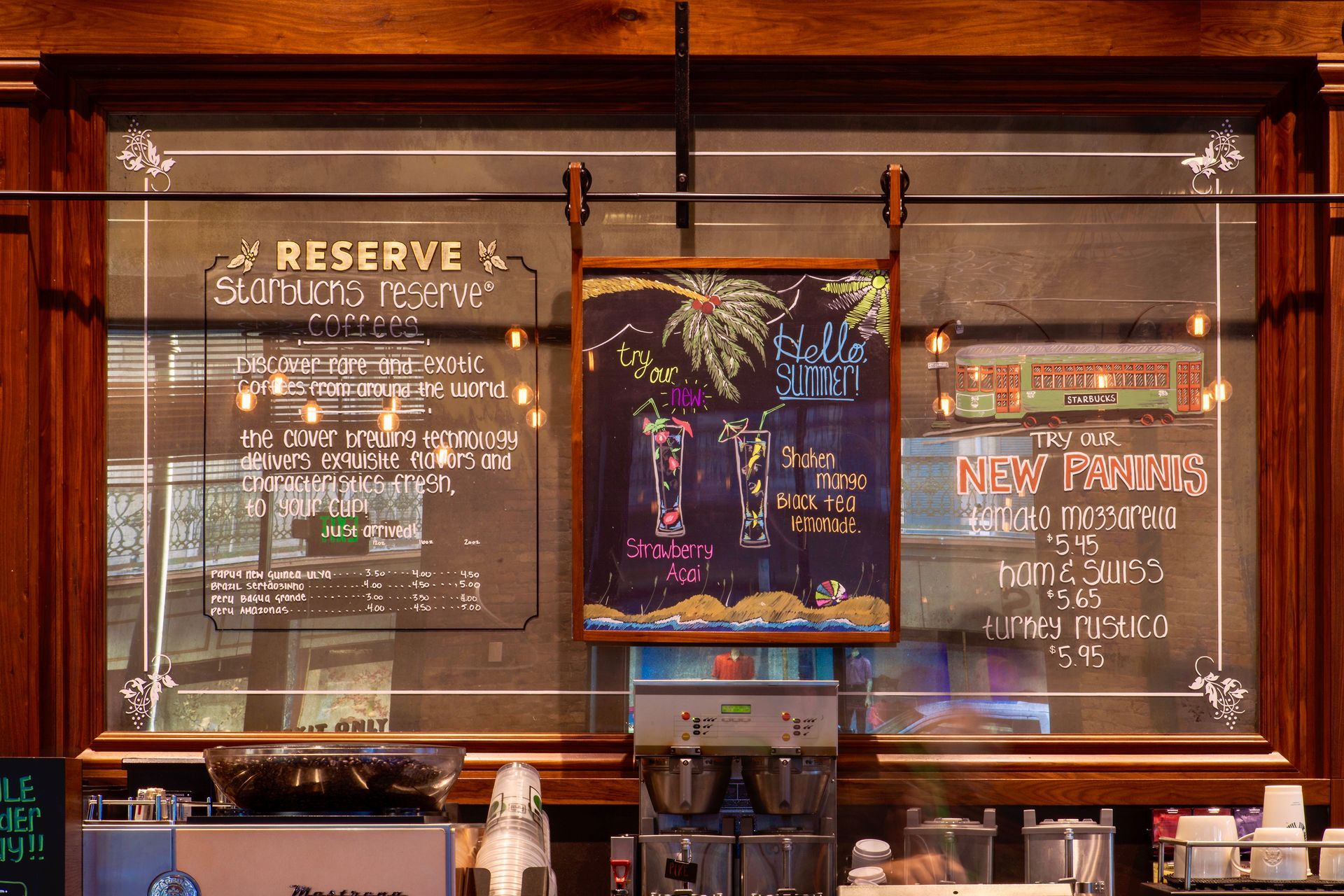 Starbucks  with a framed antique mirror that has menu written on it