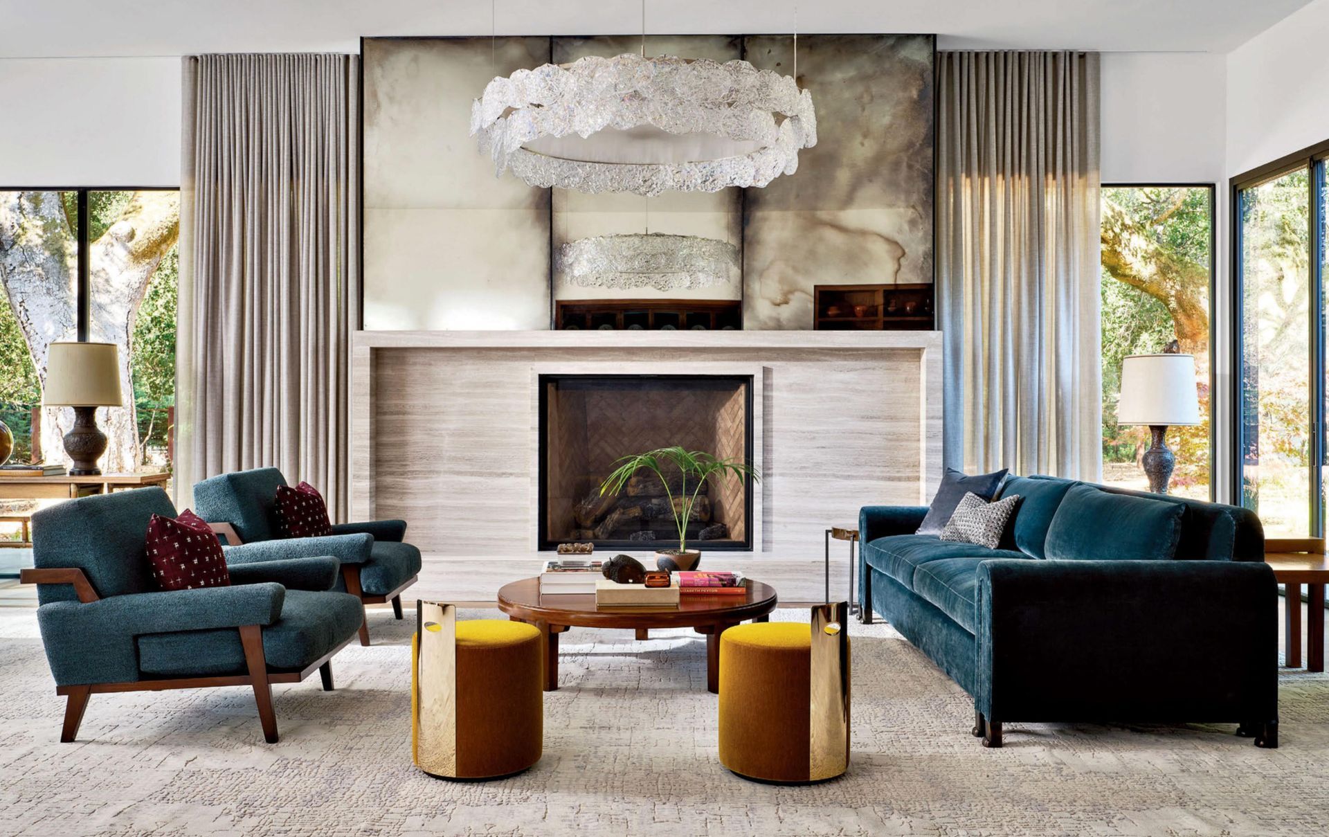 A living room filled with furniture, a fireplace, and a large antique mirror