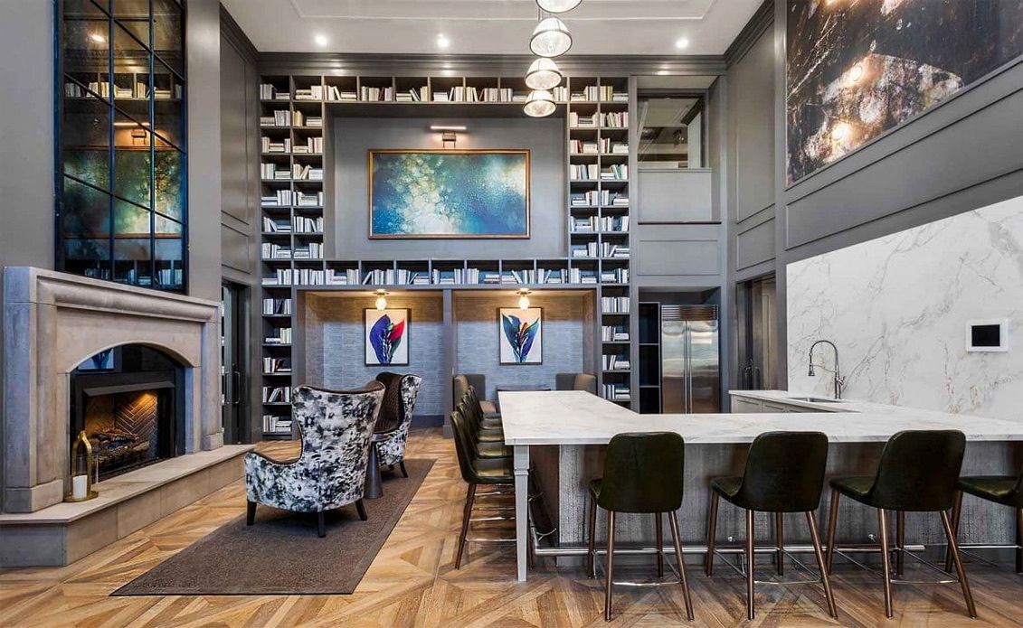 A living room with a fireplace and a bar with antique mirrors