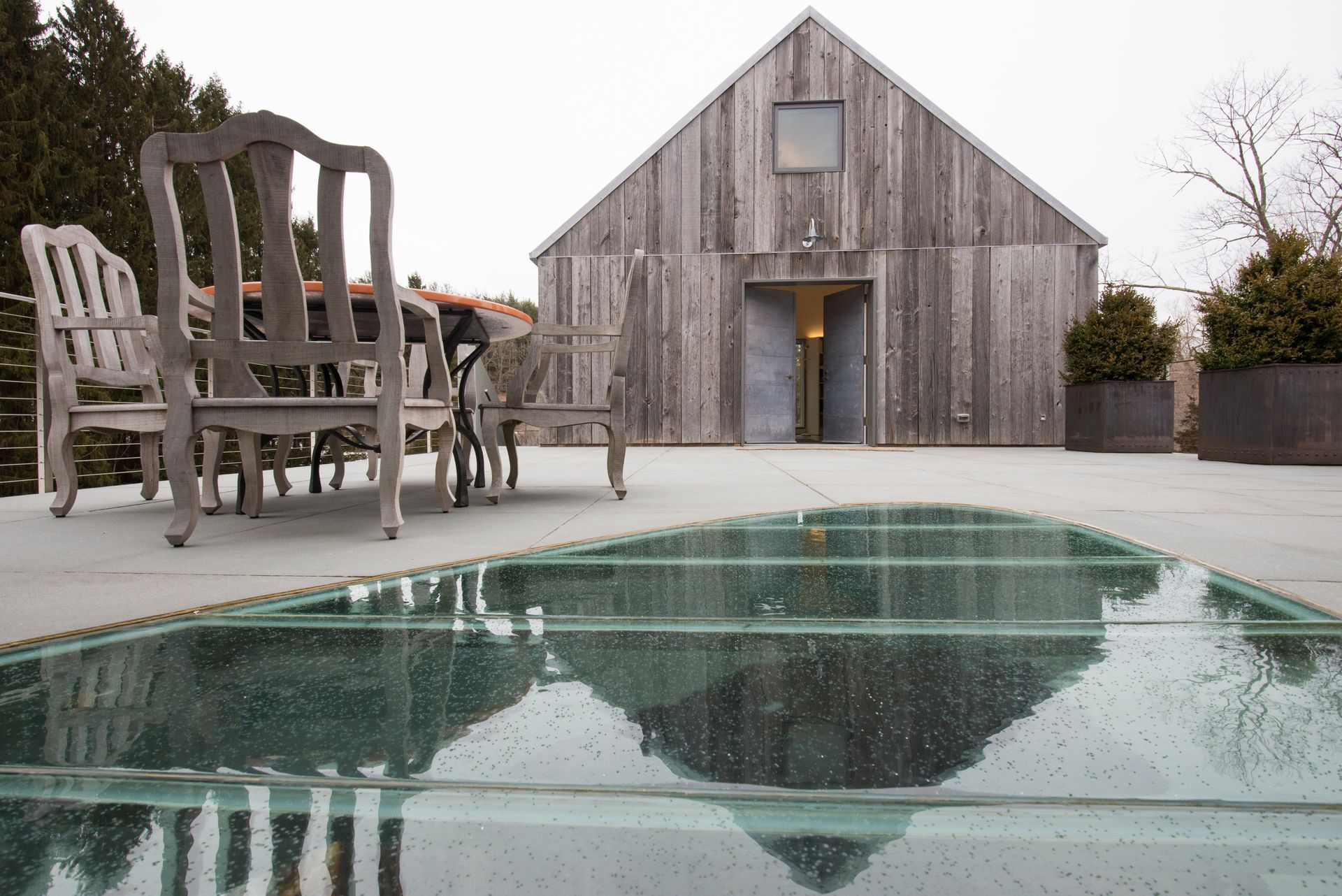 An outdoor glass floor revealing a space underneath. An outdoor glass floor revealing a space underneath.