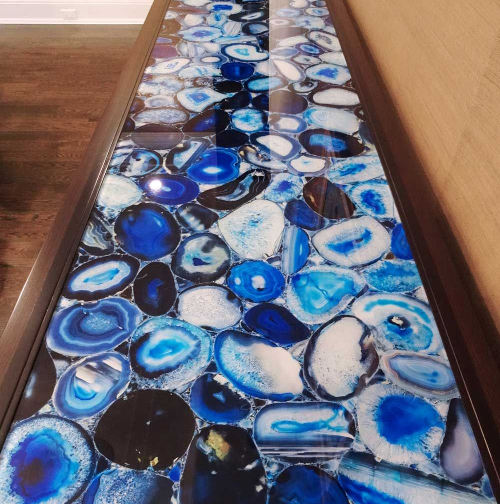 Blue and white pebble-patterned hallway runner rug between wooden walls and floor