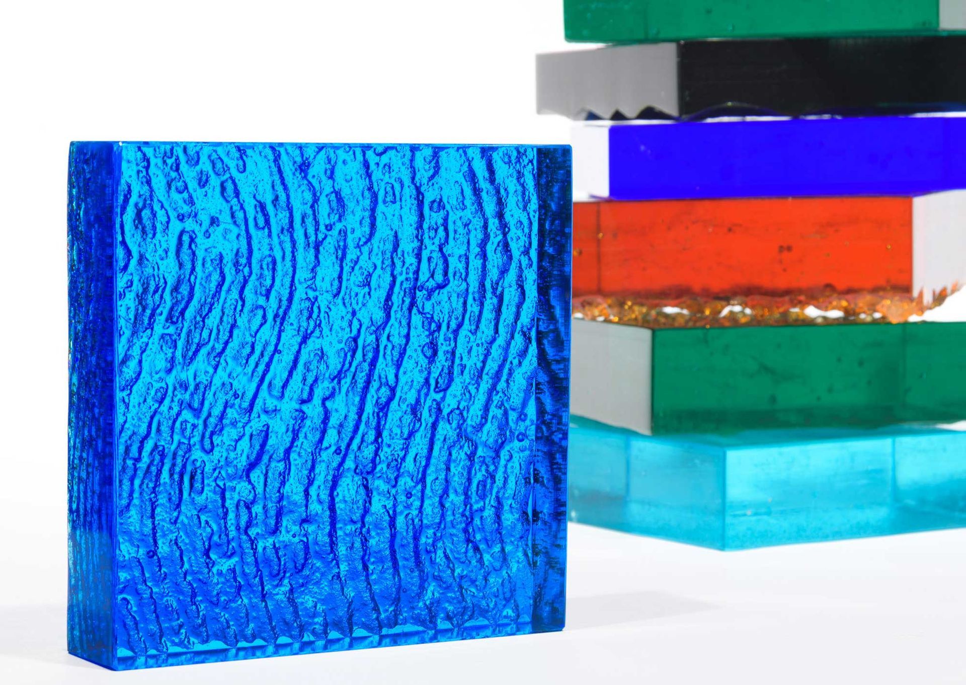 Blue textured glass block, stacked with other colored blocks.