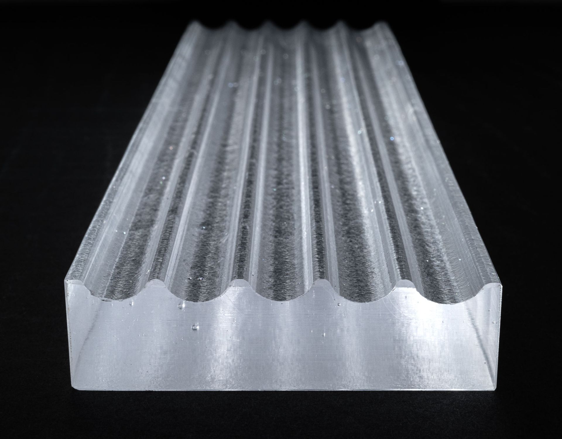 A close up of a piece of metal on a black background