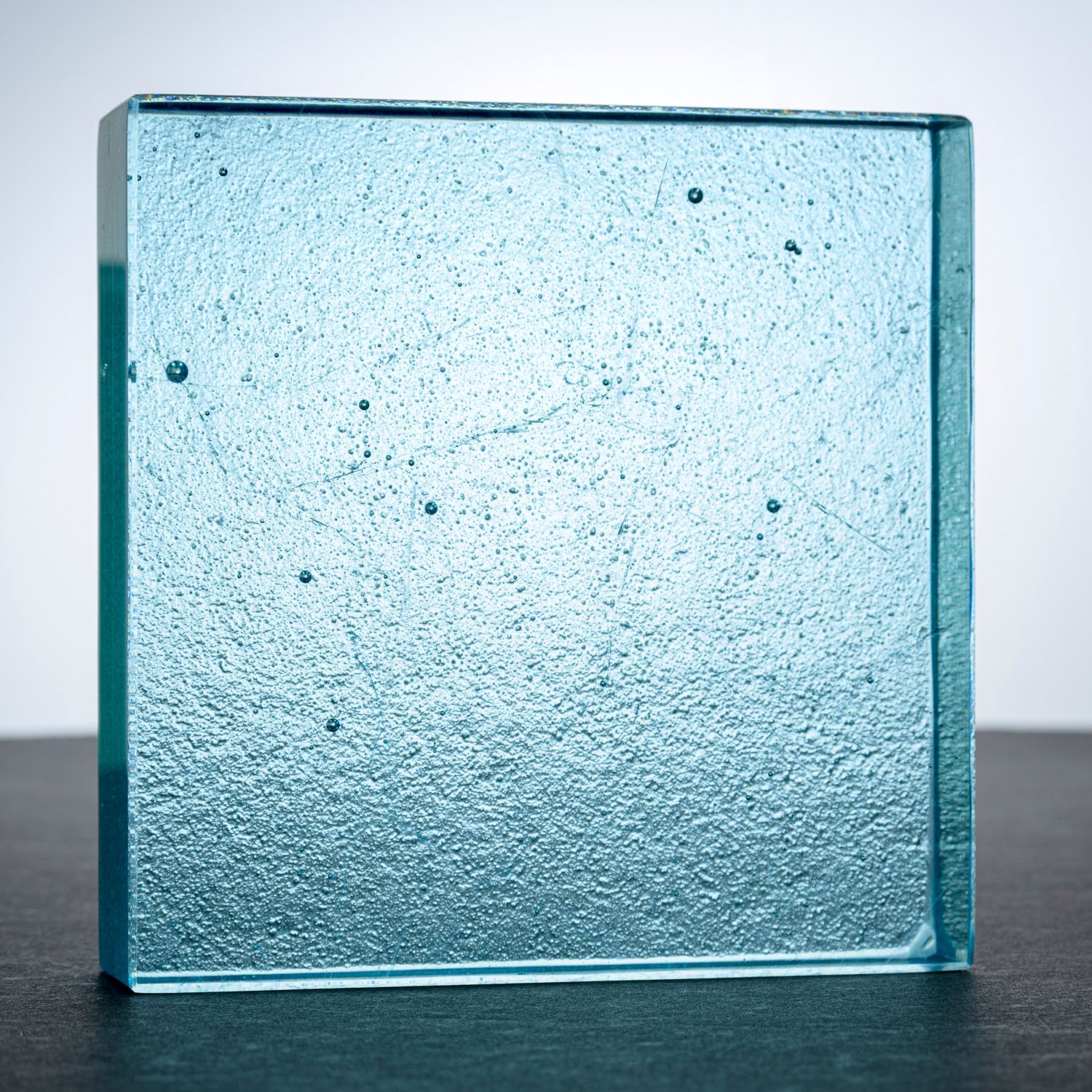 A square piece of pale blue glass counter top glass