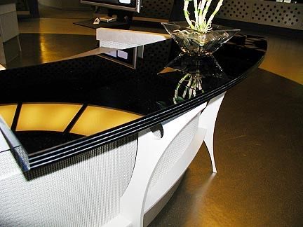 A black and white glass counter with a vase of flowers on it