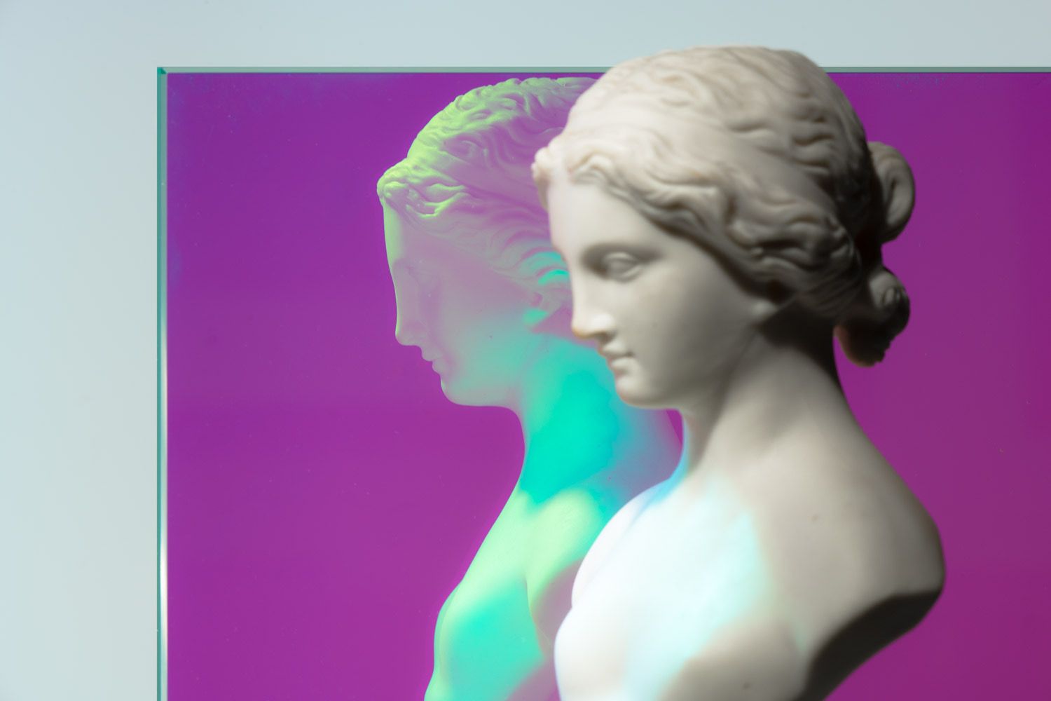 A bust against a piece of dichroic glass showing purple. A bust against a piece of dichroic glass showing purple.