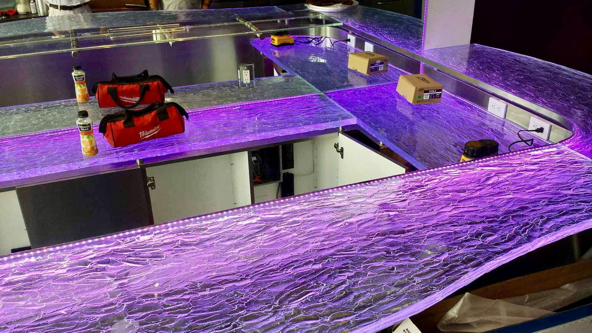 A purple glass counter top in a kitchen.