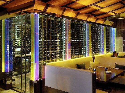 A restaurant with a lot of wine bottles on the wall