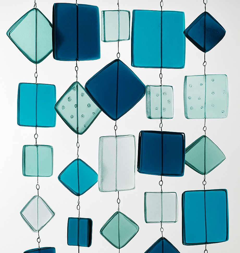 Abstract hanging glass-like squares and diamonds in teal, blue, and white on a light background