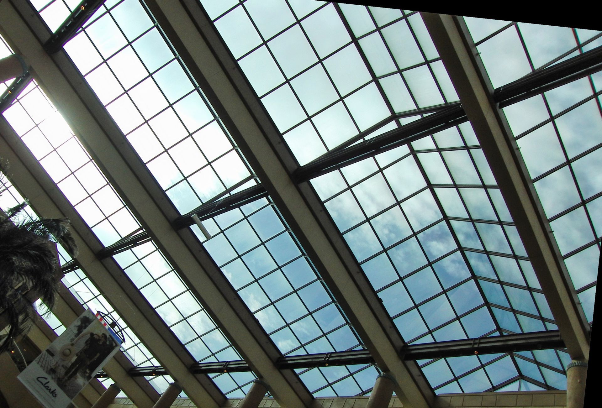 A commercial building with glass skylights and windows for the roof. A commercial building with glass skylights and windows for the roof.