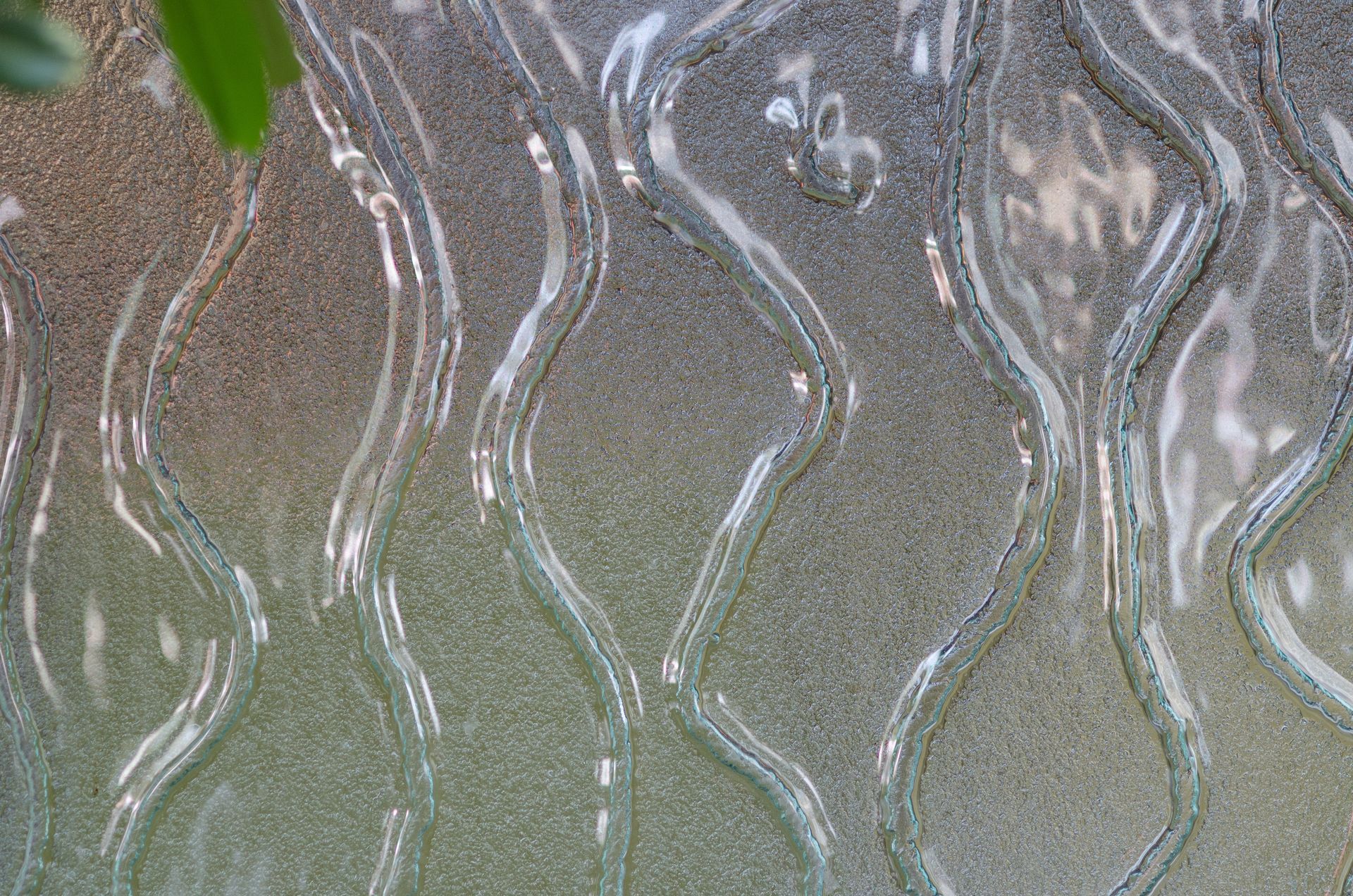 Abstract wavy glass texture with frosted gray and beige reflections