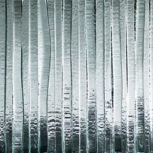 Vertical frosted glass panels with light gray and white textured reflections
