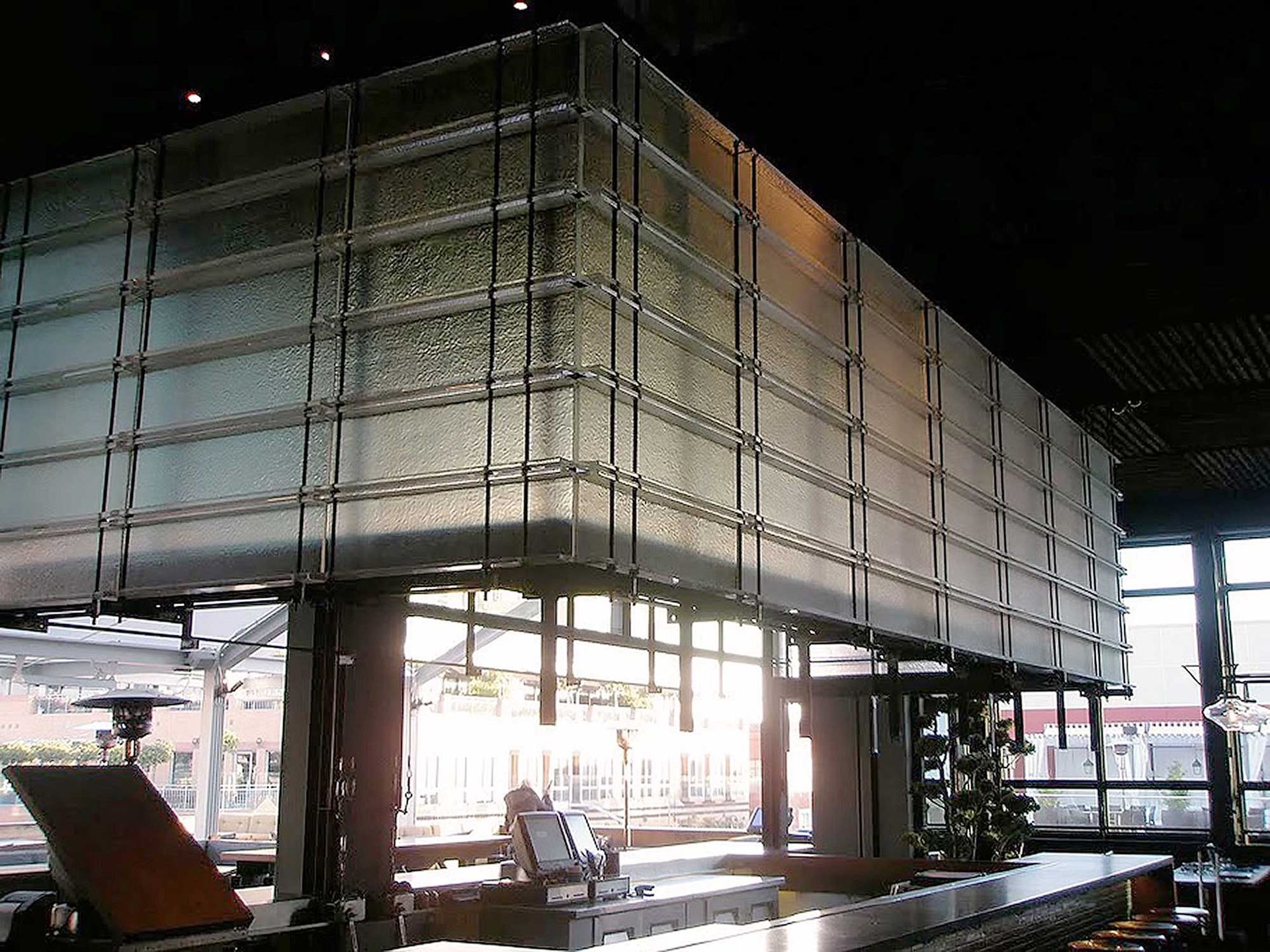 A bar with a large glass wall behind it