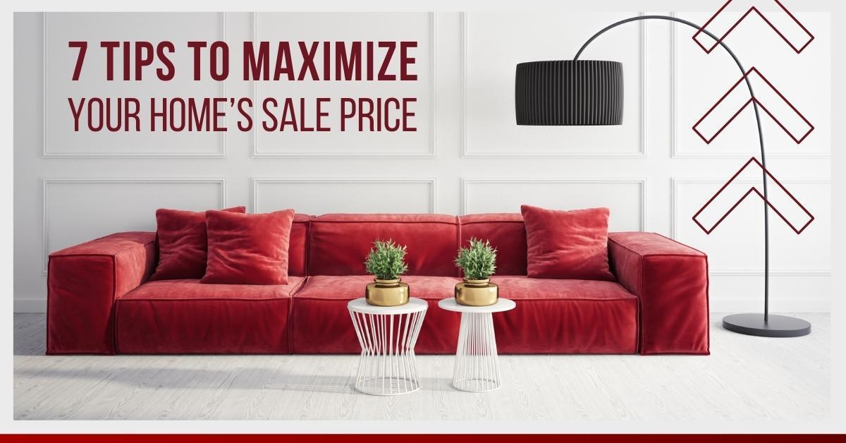 A red sofa and two small tables in a room with the text