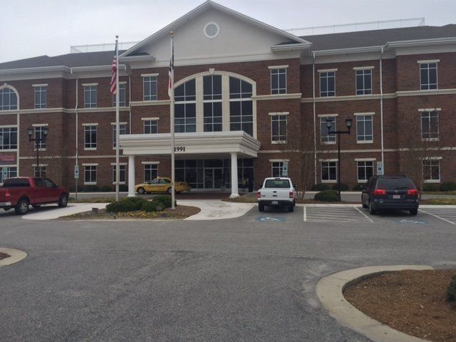 A large brick building with cars parked in front of it