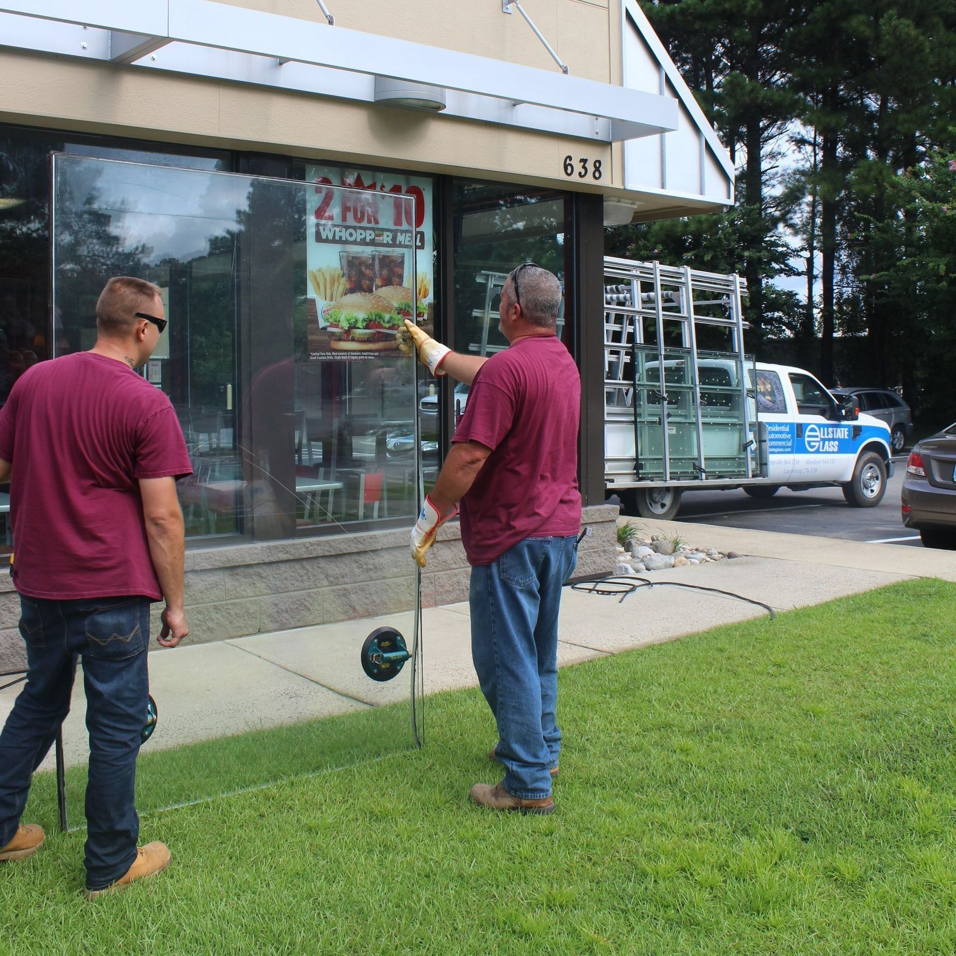 Two men standing in front of a burger king store