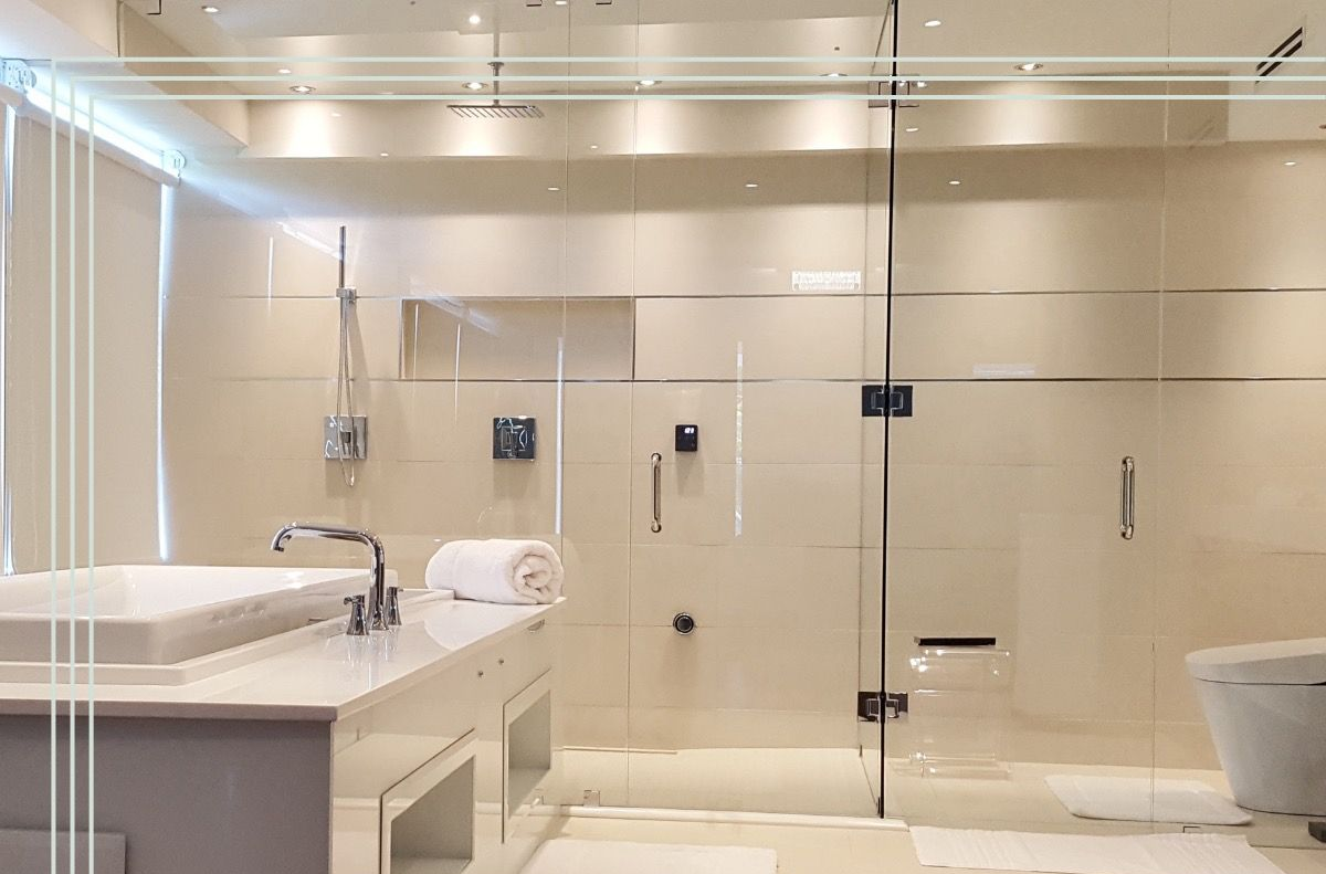 Modern bathroom with a glass shower, white walls, and a white sink and tub in Aberdeen, NC.