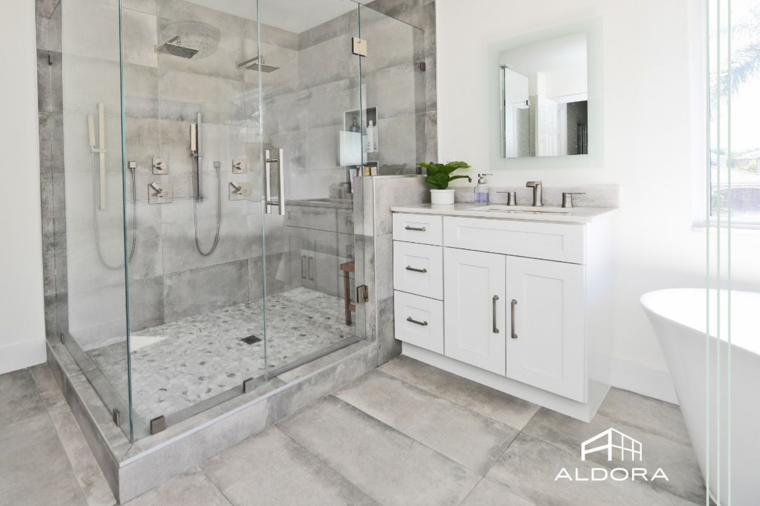 Modern bathroom with a glass shower, white walls, and a white sink and tub in Aberdeen, NC.