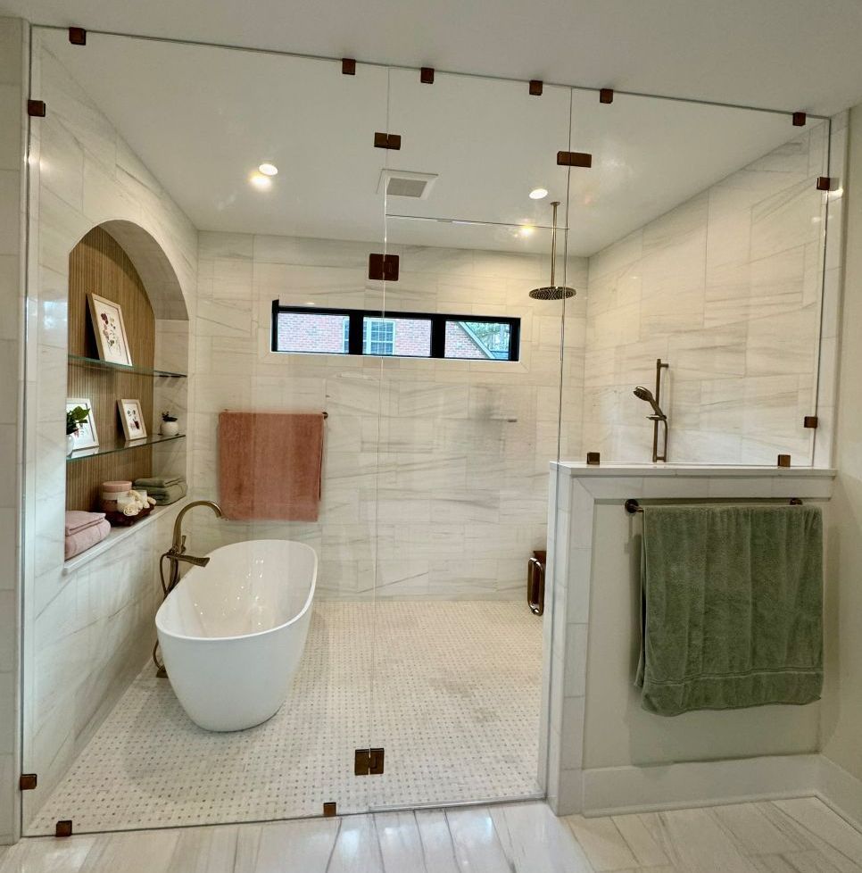 A bathroom with a bathtub and a walk in shower
