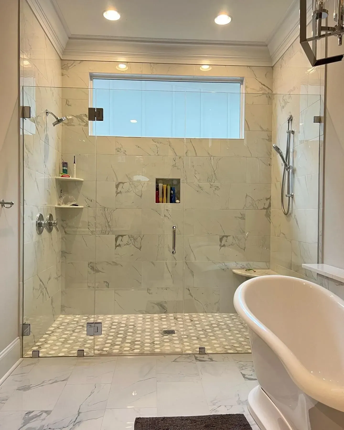 A bathroom with a walk in shower and a bathtub