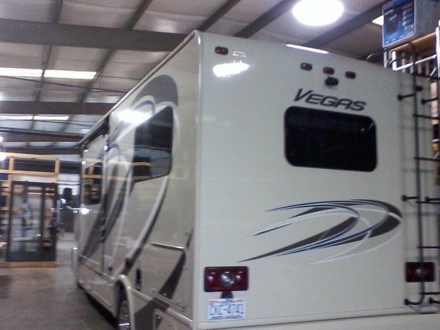 A large rv is parked in a garage.