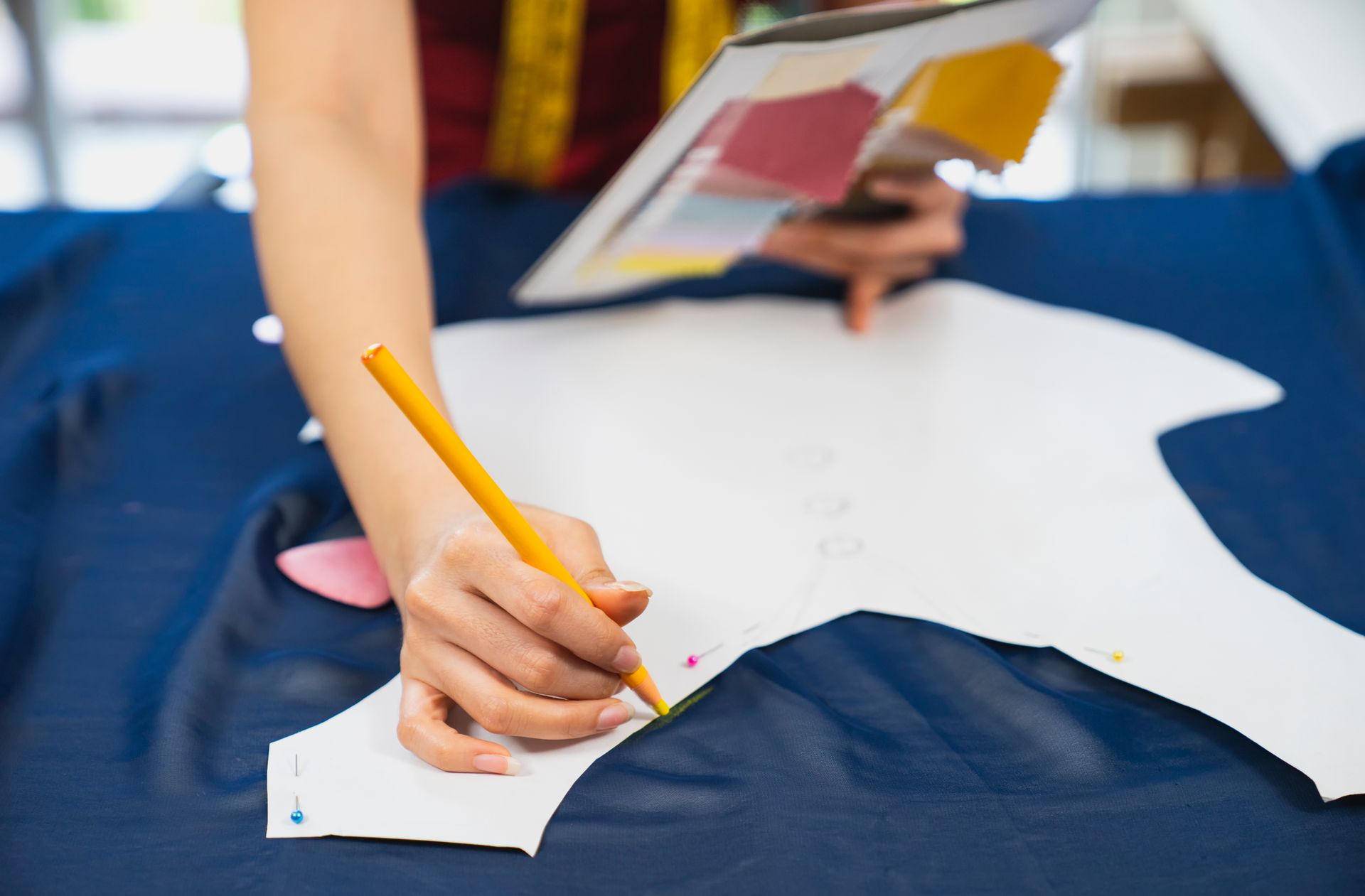 Una persona sta disegnando su un pezzo di carta con una matita.