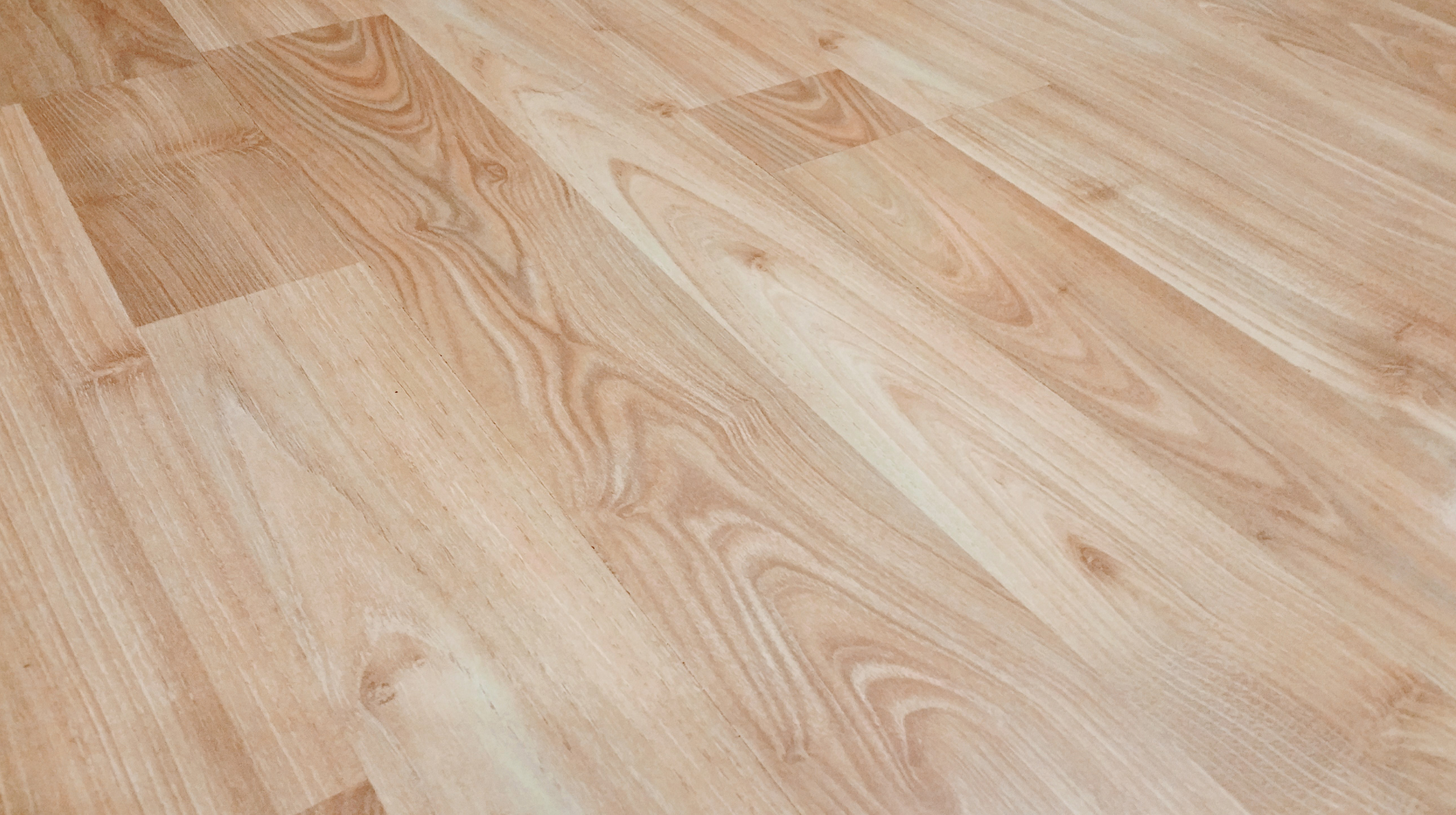 A close up of a wooden floor in a room.
