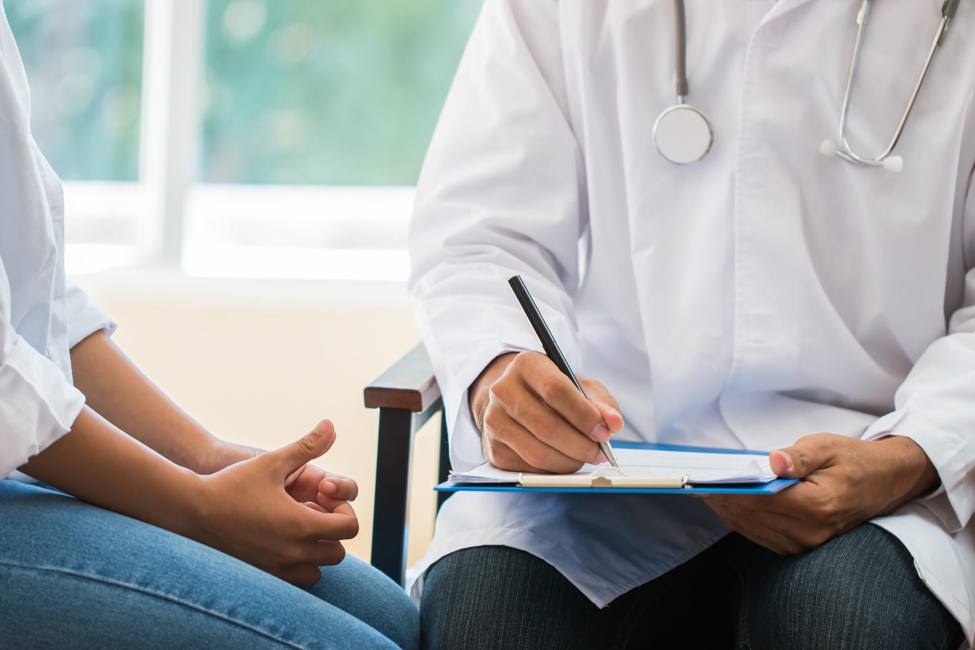 Woman patient having consultation with doctor. Woman patient having consultation with doctor.