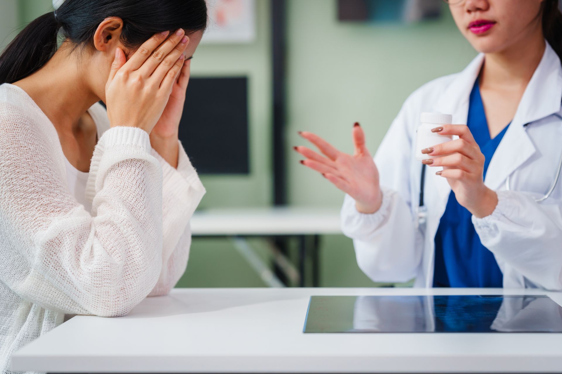 Doctor explaining medication to a distressed patient in an office setting. Doctor explaining medication to a distressed patient in an office setting.