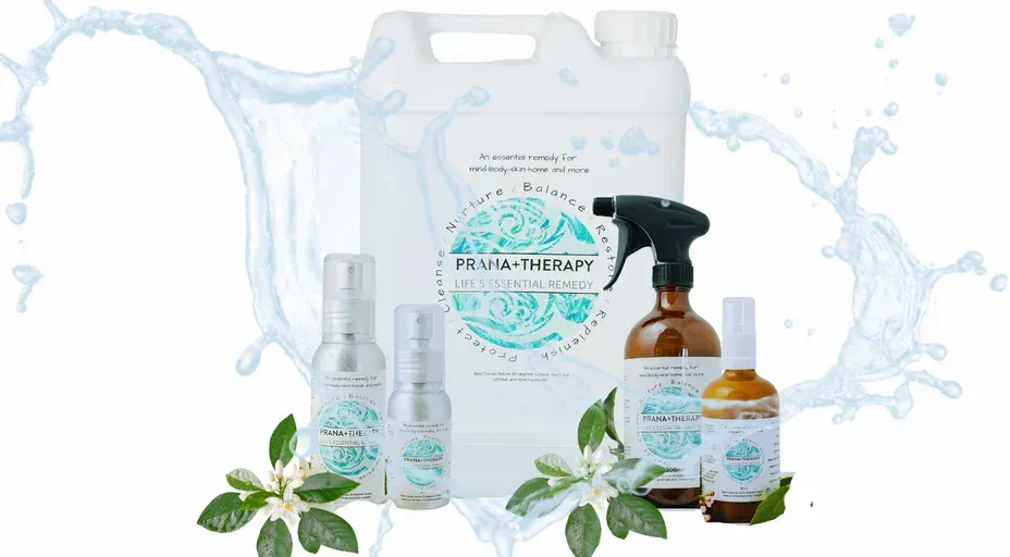 Cleaning products with a floral and aquatic design, including a jug, spray bottles, and smaller vials.