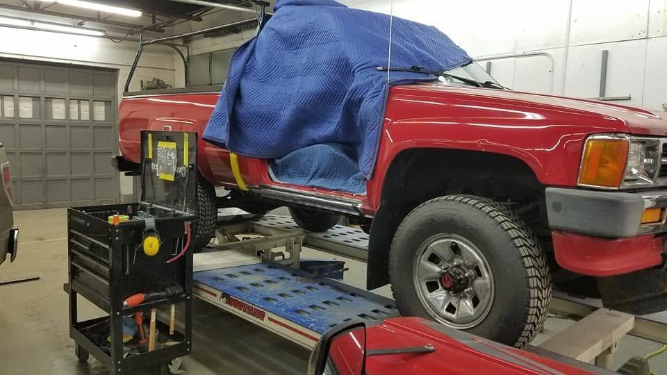Red SUV On Lift For Auto Repair Inspection | Kabilian's Car Kare