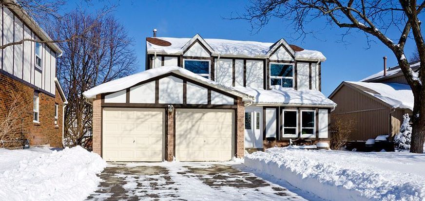 Grand Rapids, MI home covered in snow in winter