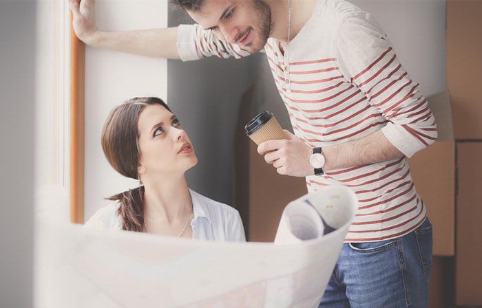 Young, married couple looks over renovation plans