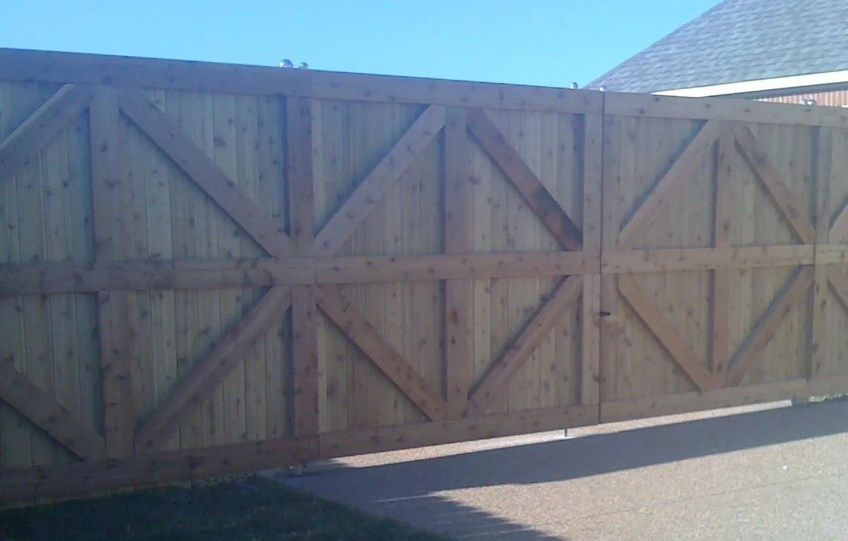 A wooden fence with a blue sky in the background