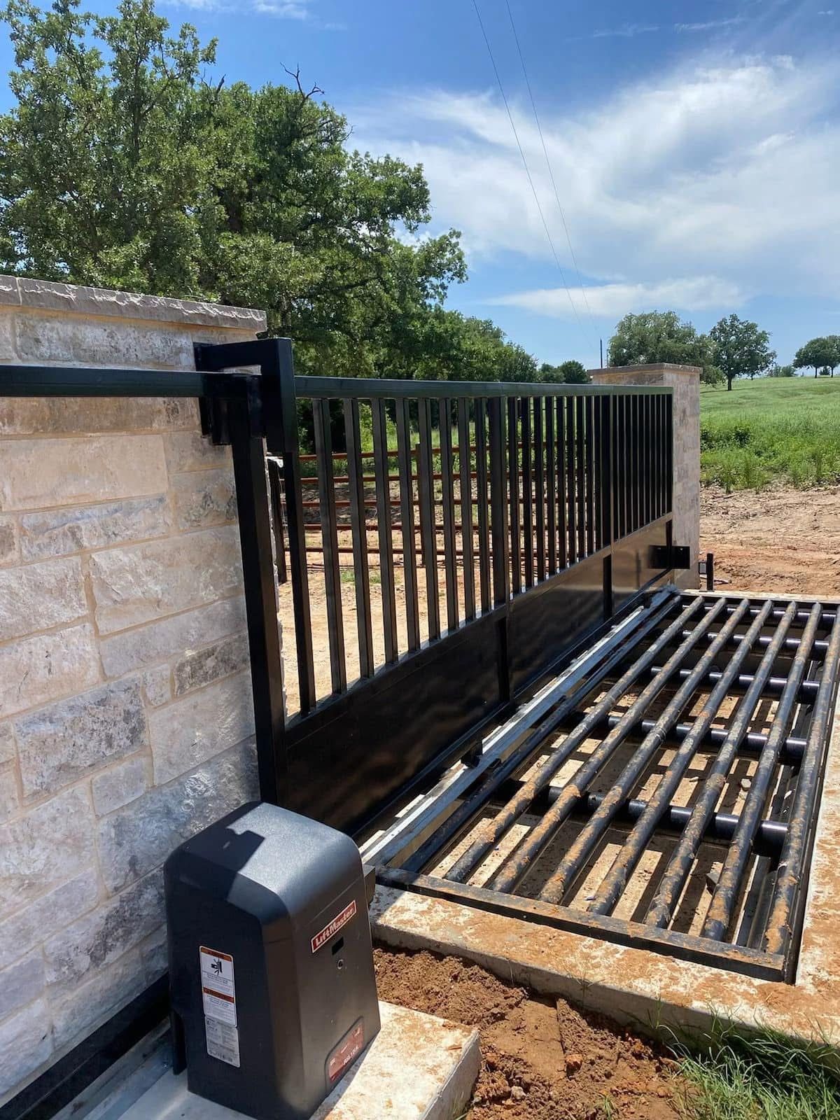 A man is using a fingerprint scanner to open a gate.