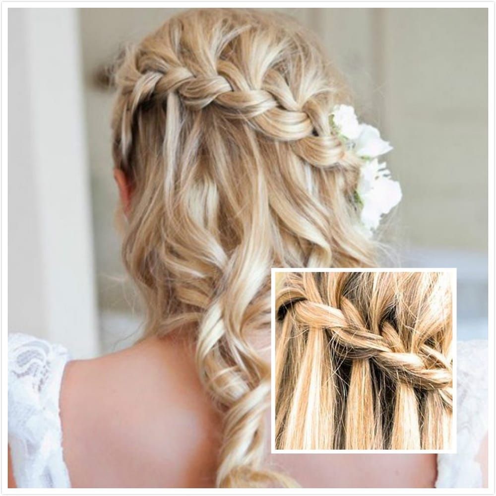 A woman is wearing a braided hairstyle with a flower in her hair
