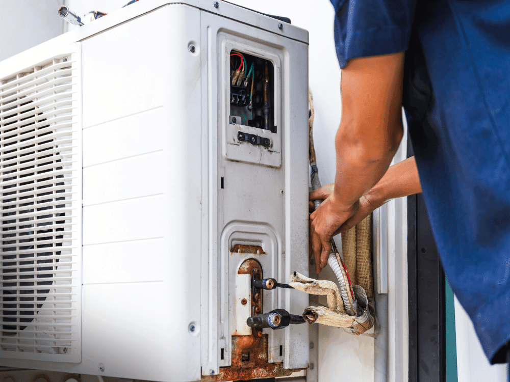 Home inspector examining a residential HVAC system