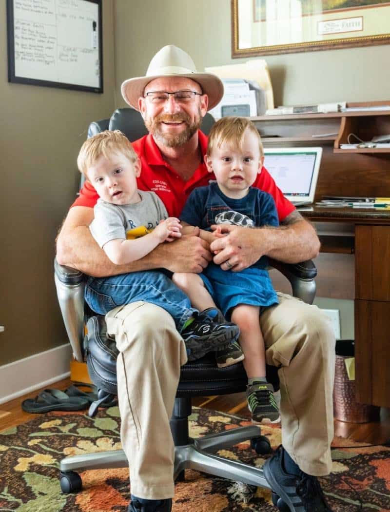 Home inspection professional with two children in an office