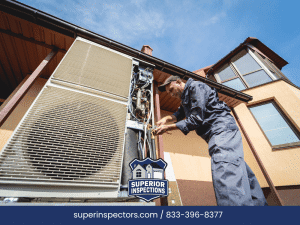 Worker inspecting damaged outdoor HVAC unit on a house exterior